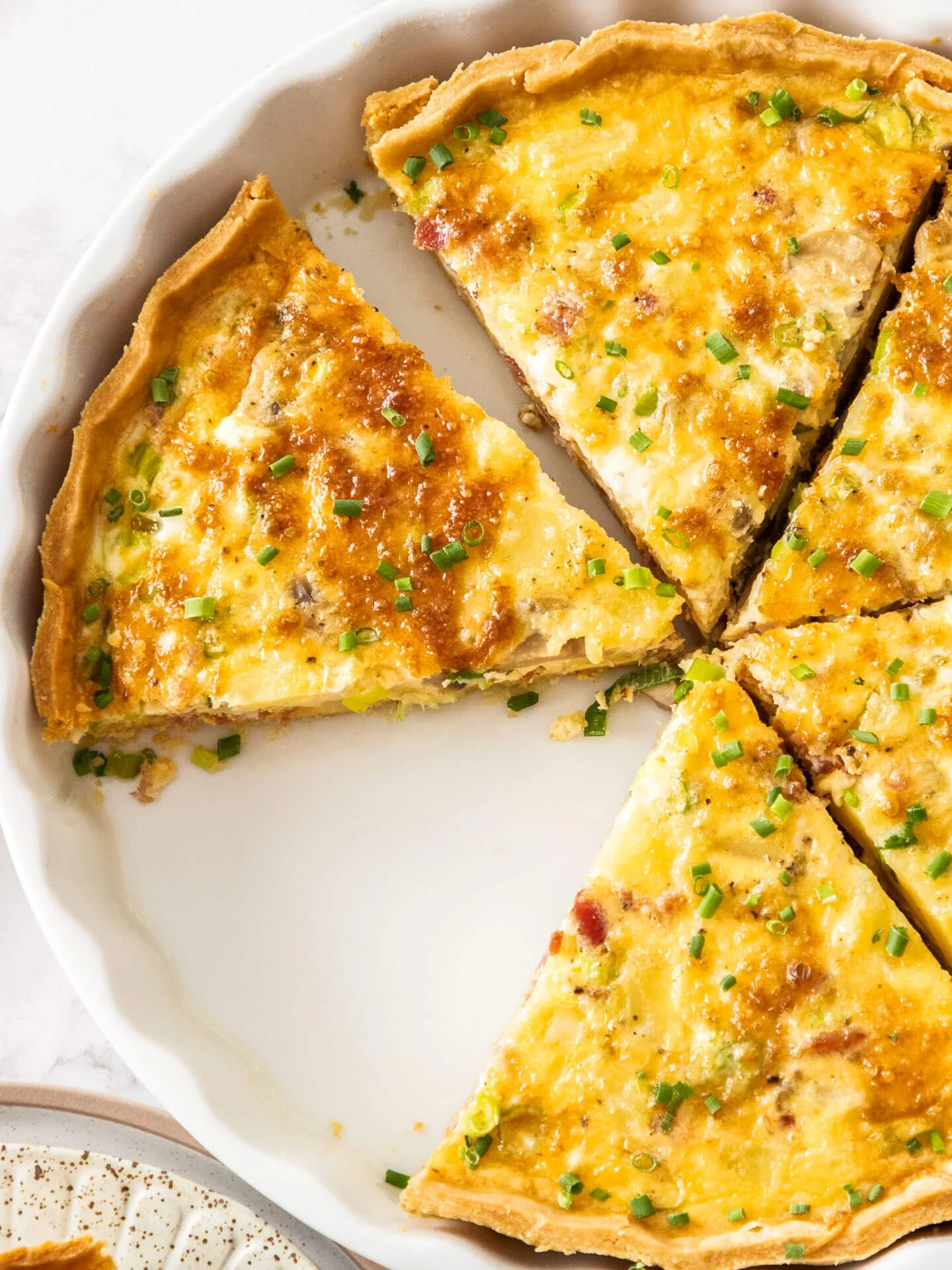A golden, mouthwatering Bacon & Potato Quiche filled with creamy custard, crispy bacon, and a surprising twist of flavor.