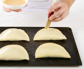 After carefully folding and sealing your apple turnovers, itâs time to add the final touch: the egg wash and chilling.