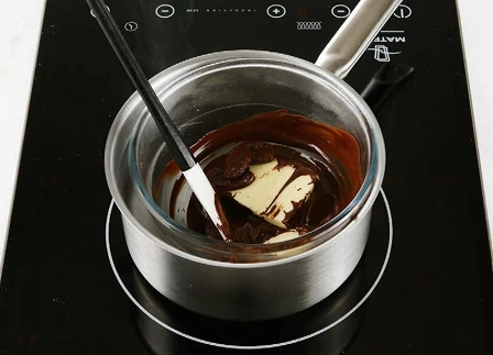 Butter and dark chocolate melting smoothly over a bain-marie to create the rich base for homemade brownies."