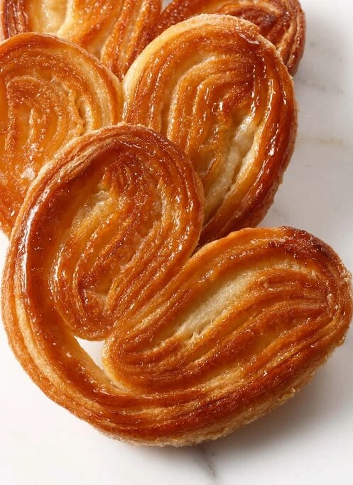 o maintain their crisp texture and prevent sticking, be sure to remove your palmiers from the baking tray right after theyâre done