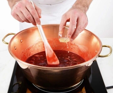 Once the syrup reaches the right temperature, carefully add your ripe strawberries. 