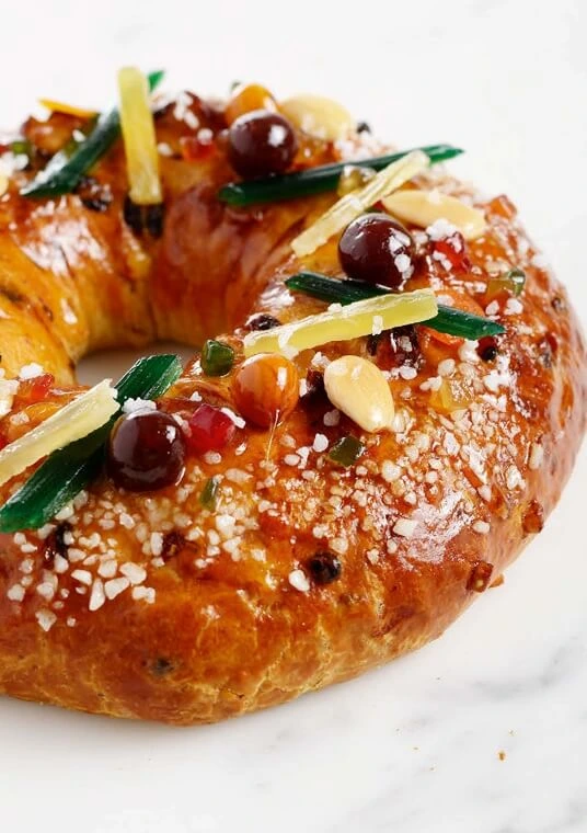 Close-up of a golden, fluted Kougelhopf cake, showcasing its tender crumb and delicate sugar glaze, symbolizing traditional Alsatian baking secrets.