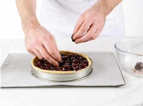 Photo of a smooth, creamy clafoutis custard mixture in a bowl, ready to be poured over the fruit.