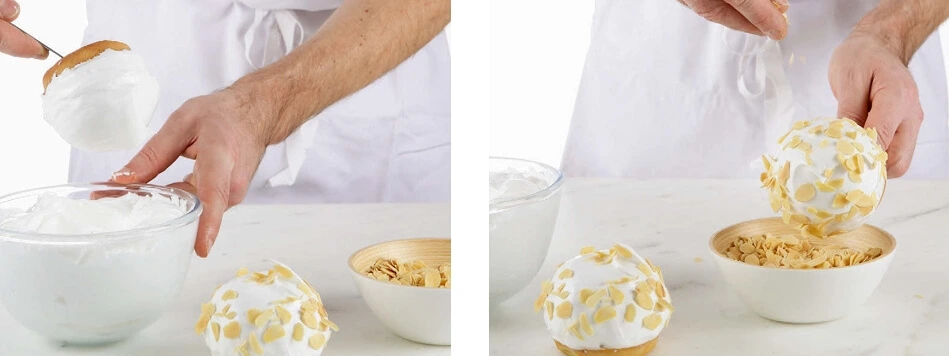 A glossy, stiff Italian meringue in a mixing bowl, with a glossy sheen and firm peaks.