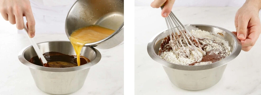 Close-up of a hand folding sifted flour into a glossy chocolate batter using a spatula, showing the texture of the moelleux au chocolat mixture during preparation.