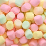 "Homemade vanilla marshmallows cut into cubes and dusted with powdered sugar on a tray"